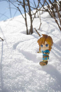 Link from the video game Breath of the Wild, snowboarding with a shield
