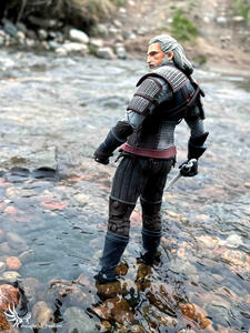 Geralt (witcher 3) standing in a river with a sword.